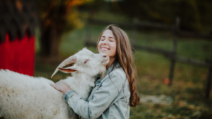 woman hugging goat