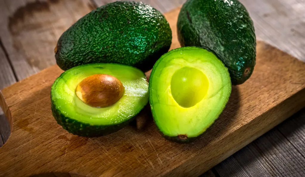 avocados on a wooden chopping board