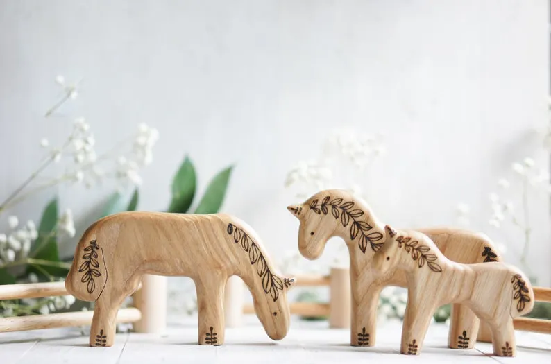 Family of wooden horses  arranged neatly on a table