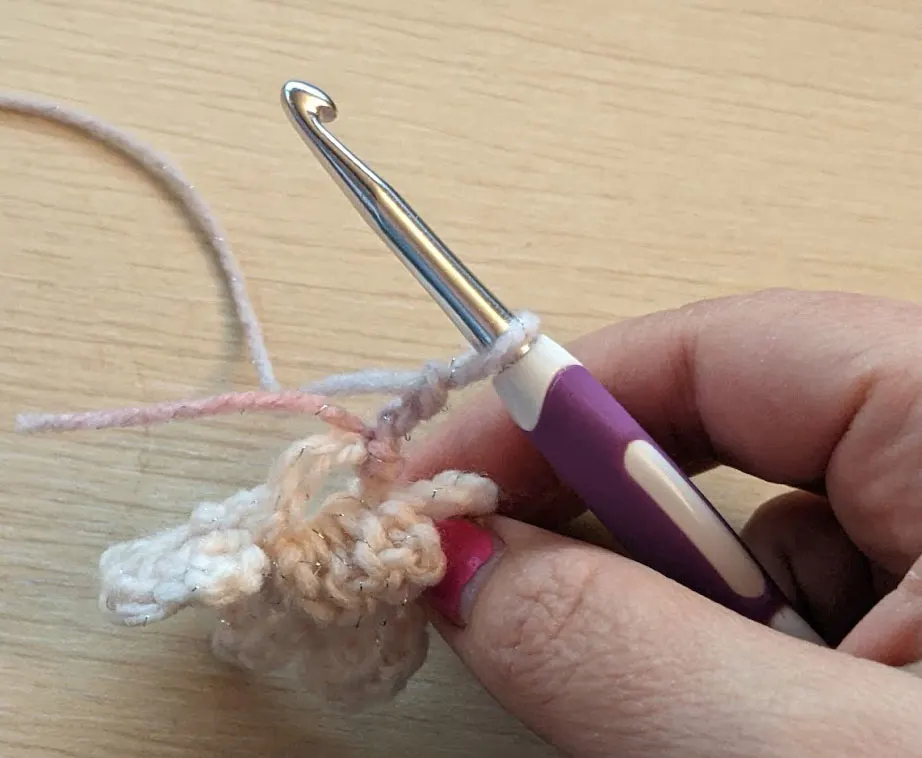 close up detail of the loop for starting a new row of petals on a crochet flower