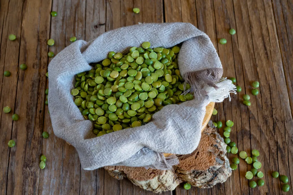 sack of split peas on wooden table 