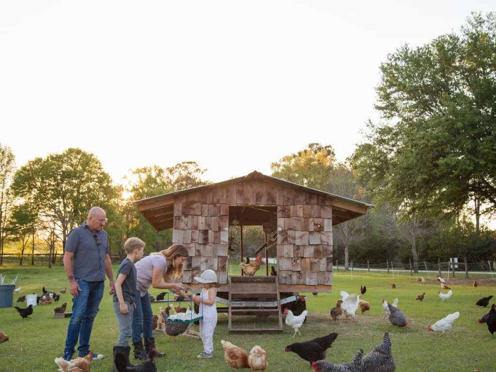 family near chicken coop