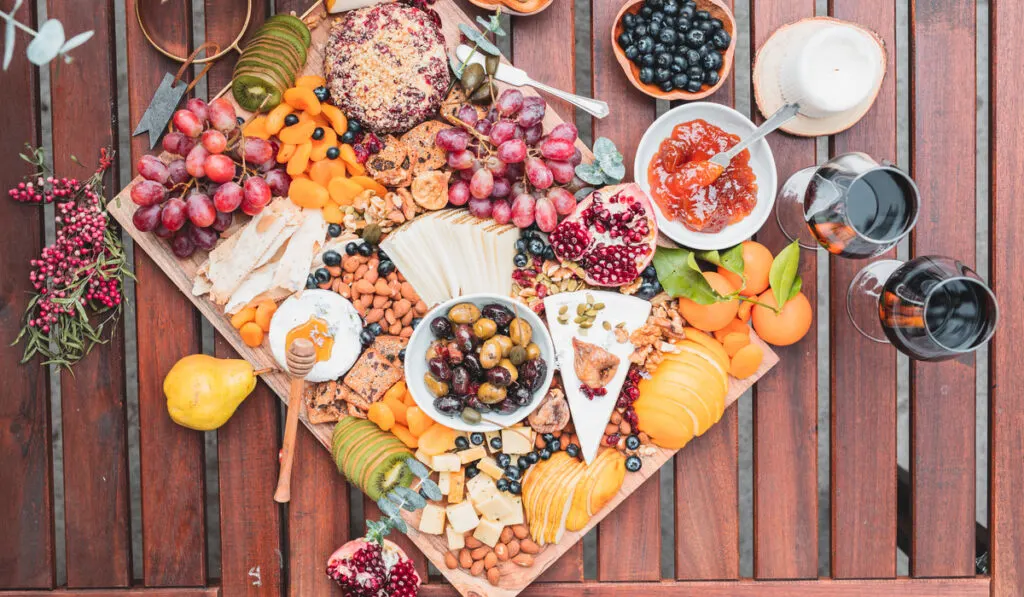 Artisan charcuterie boards different fruits and almond food on the table