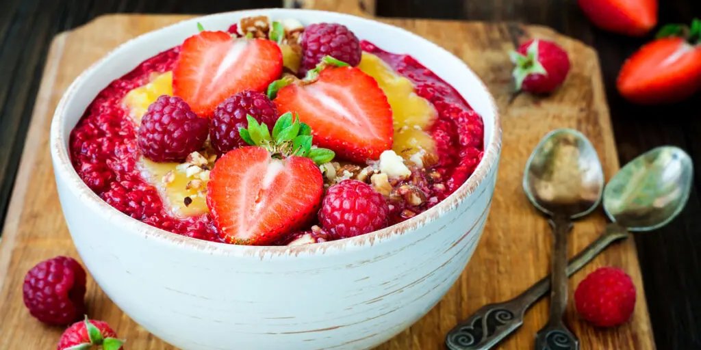 Healthy breakfast. Smoothie bowl topped with hazelnuts and oat granola