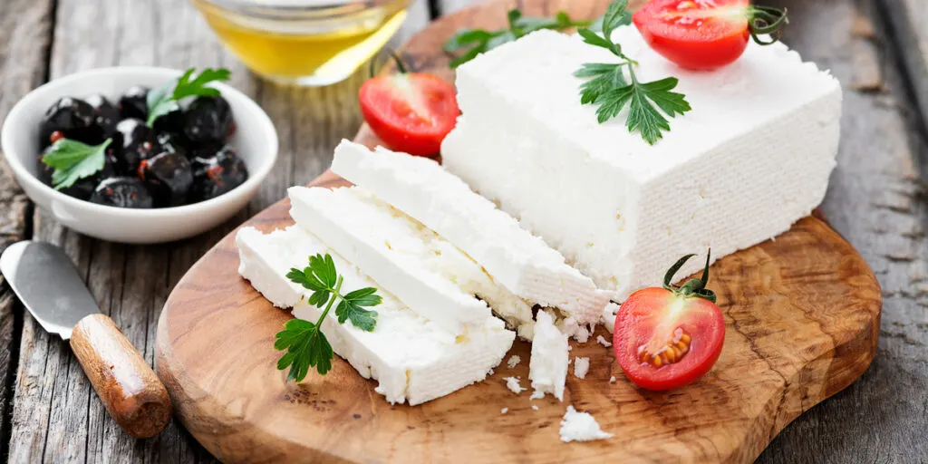 Sliced Feta cheese with herbs and olive oil