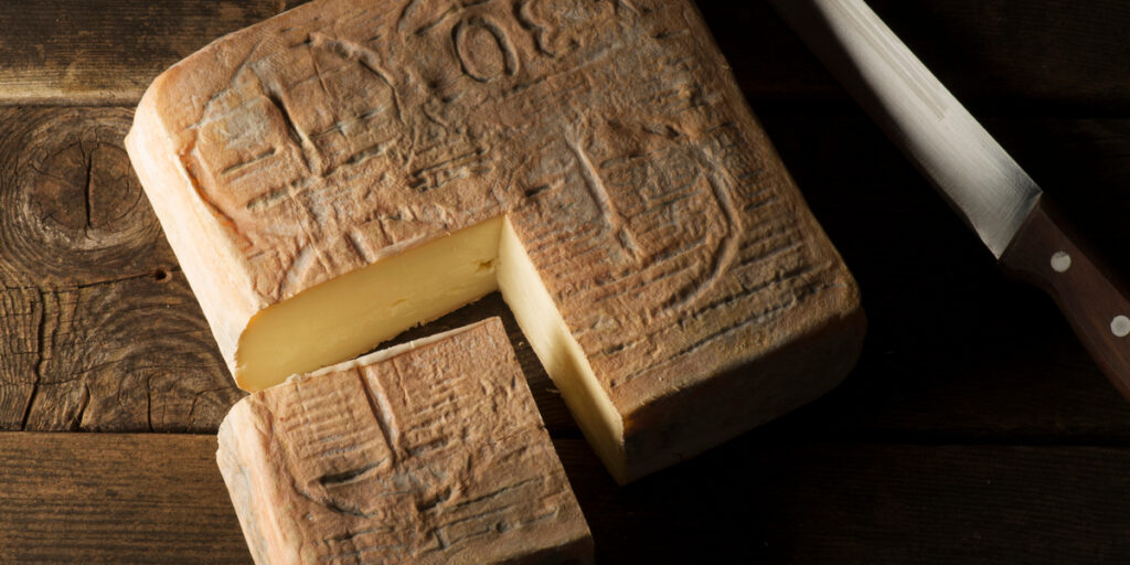 Taleggio cheese on the wooden table