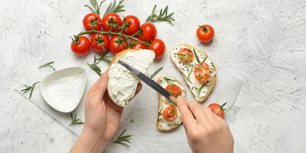 Woman making tasty sandwich