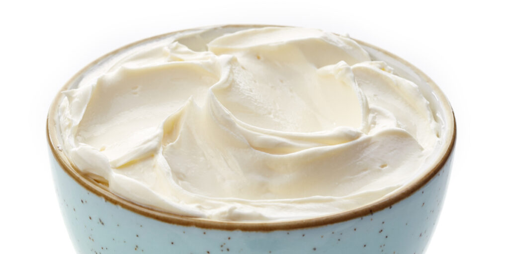 bowl of cream cheese on white background