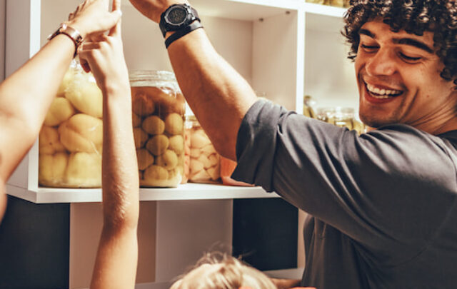 cropped-siblings-pointing-and-helping-each-other-in-kitchen-pantry-ee220427.jpg