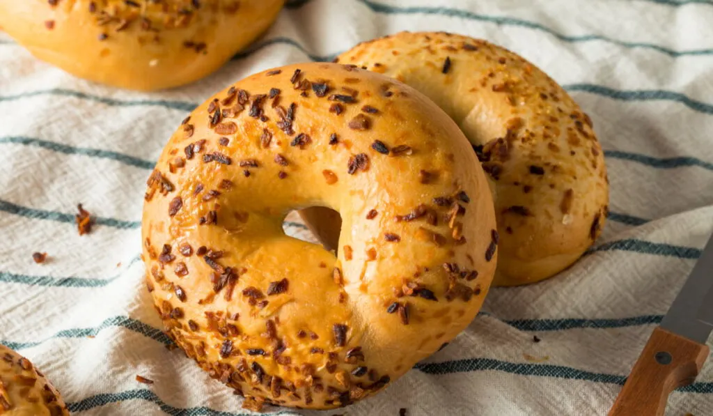 fresh from the oven onion bagels on a kitchen towel