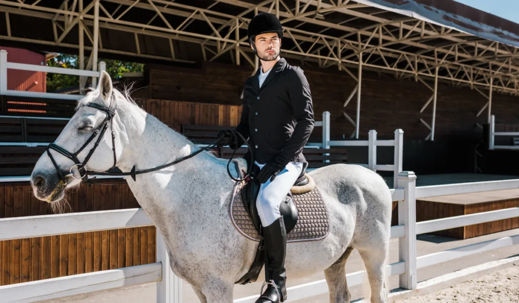 handsome male equestrian riding white horse ee220401