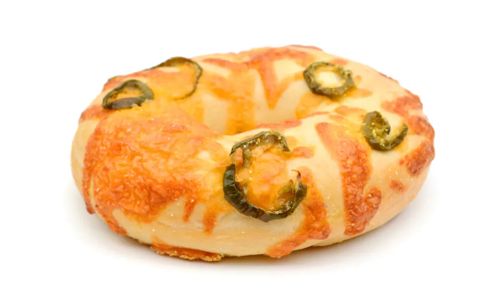 one jalapeno cheddar cheese bagel on white background
