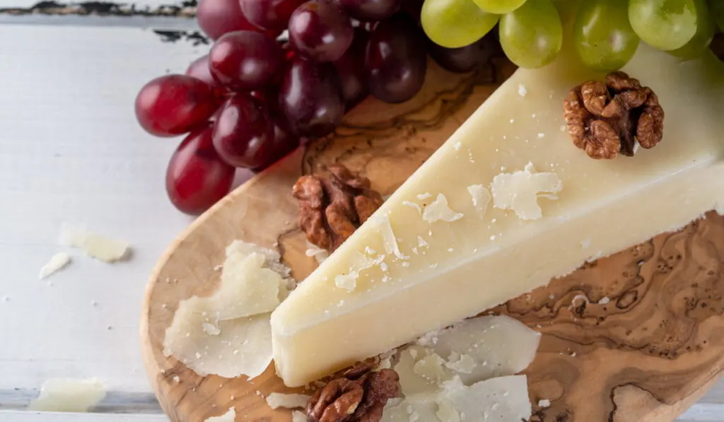 sliced pecorino romano with walnuts and grapes 