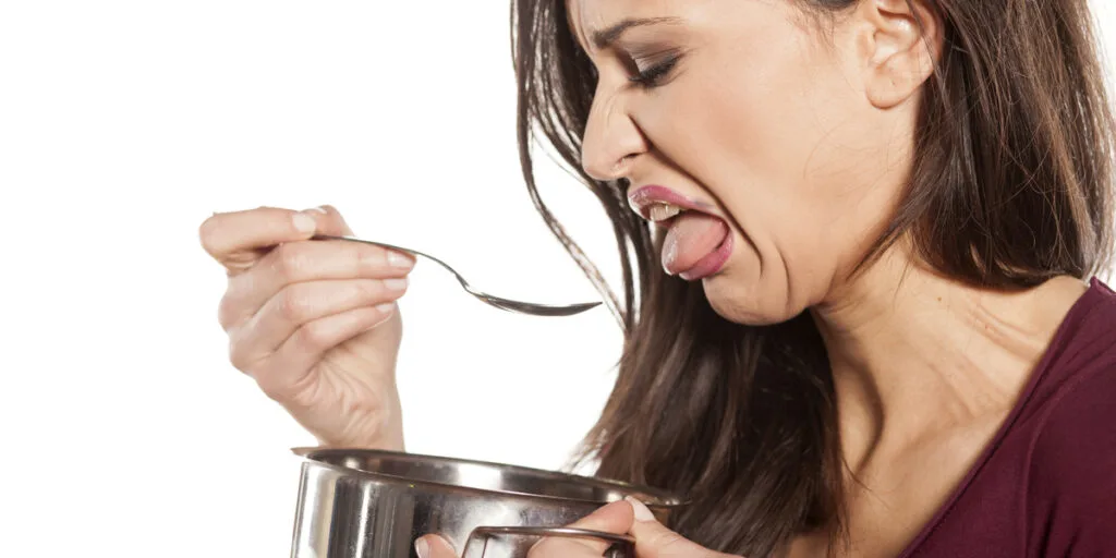 unhappy young woman is disgusted by the taste of her food