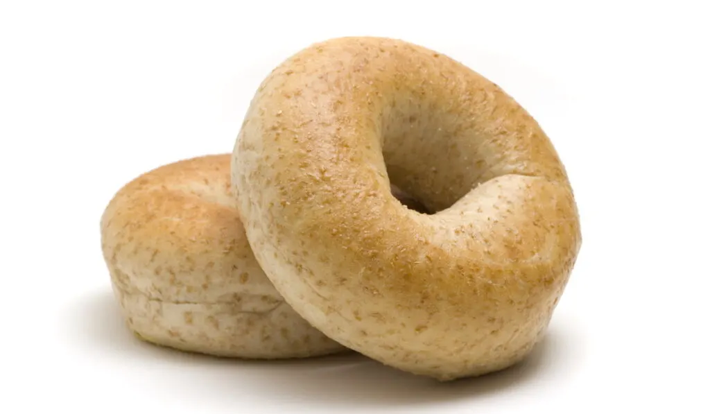 whole wheat bagels on white background