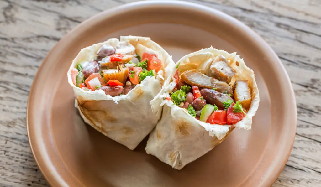 Chicken burrito on beige plate 