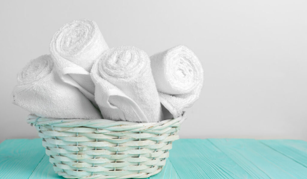 Clean soft white towels on wooden table