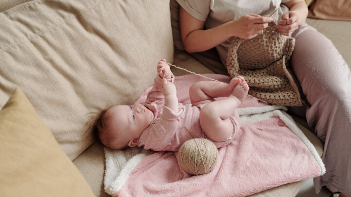 Cute-baby-girl-playing-with-yarn-of-woolen-threads