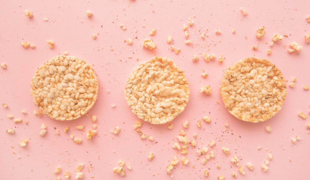 Flat lay crunchy rice cakes on pink background