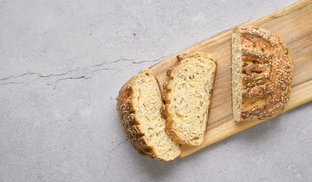 Fresh Gluten-Free oats bread on wooden chopping board 