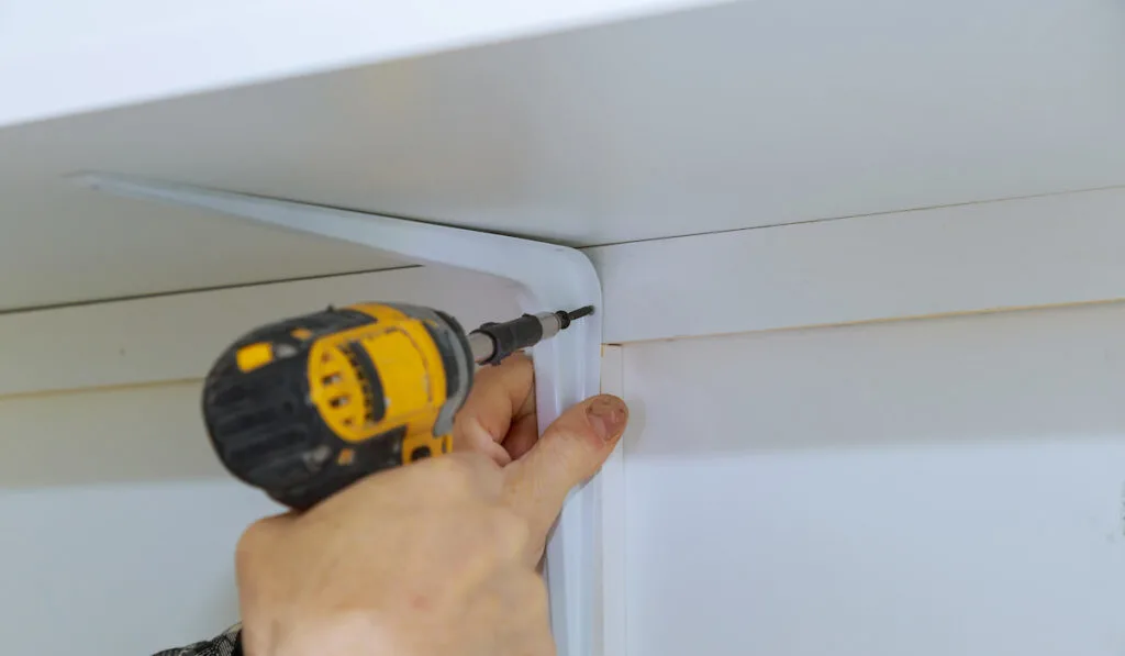 Man installing wooden shelves on brackets installation of shelves 