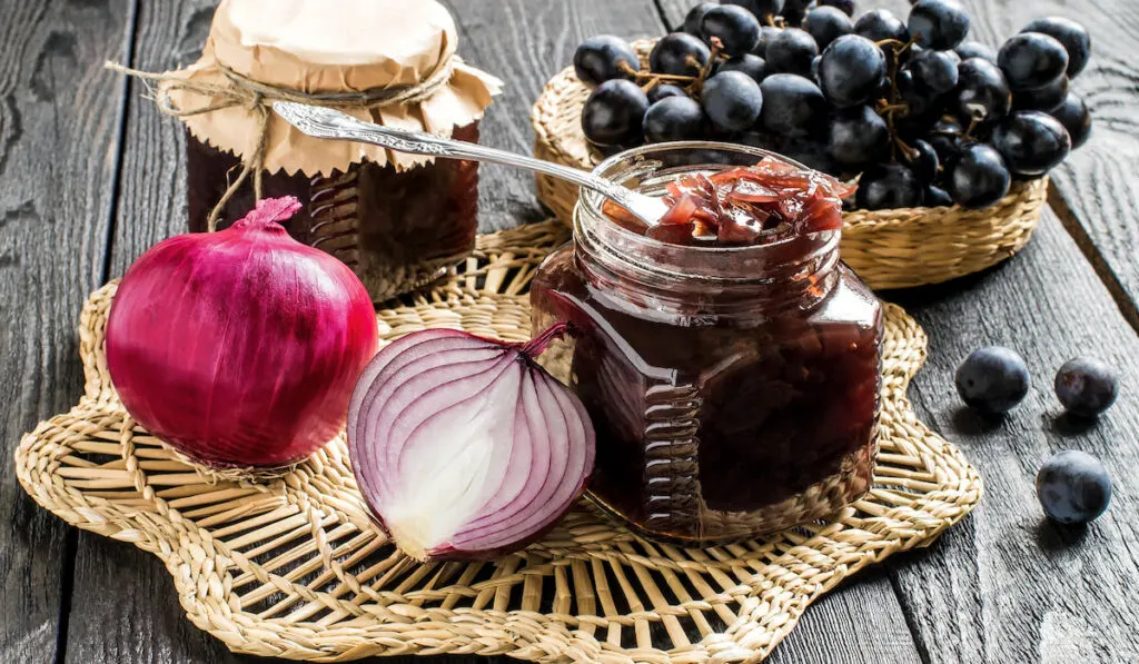 Onion jam with grapes in glass jars 