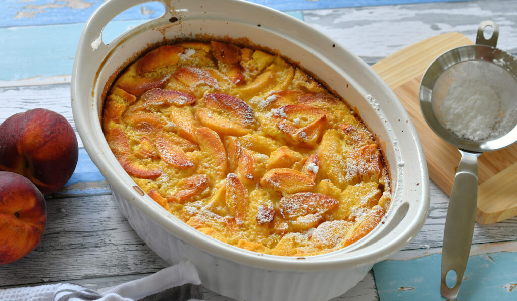 Peach Cobbler french baked desset peach sprinkled with powdered sugar 