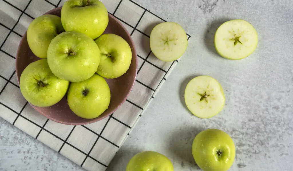 Pile of green apples on white background 