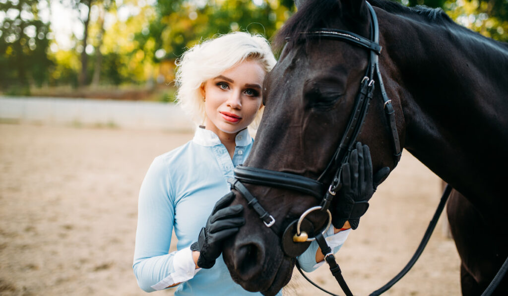 Portrait of woman and black horse, horseback riding 
