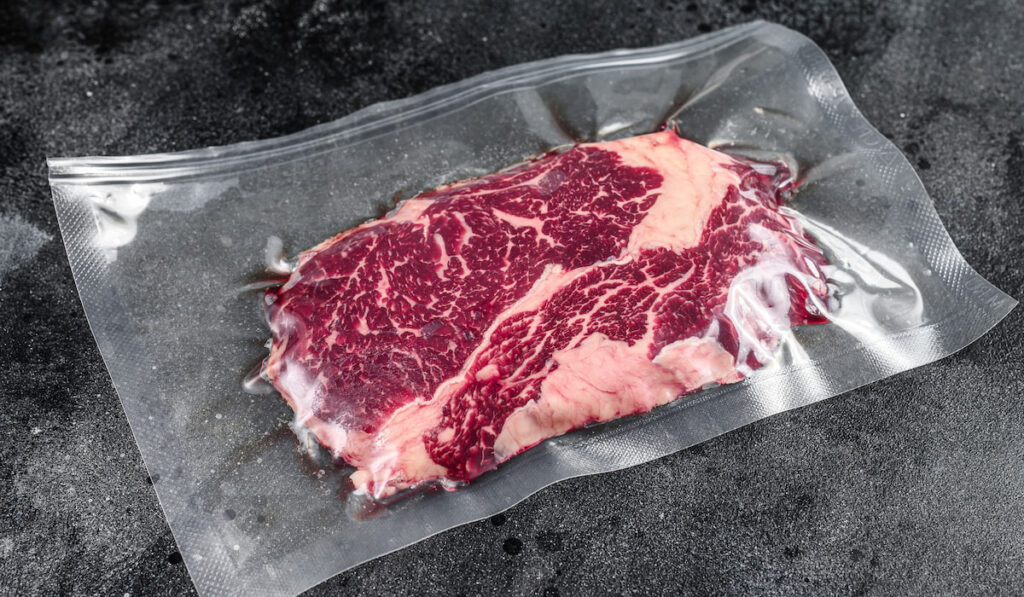Raw rib eye beef meat steak in vacuum packaging