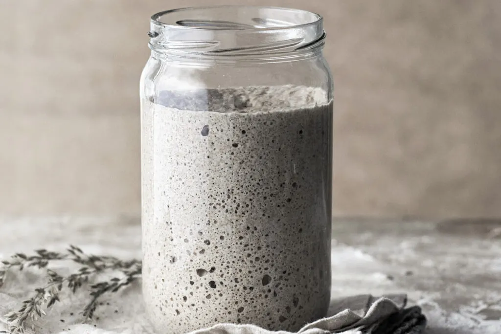 Sourdough starter in a glass jar with mold