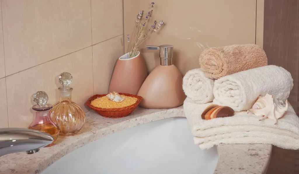 Stack of Linen Towels with a Soap Dispenser in a Bathroom