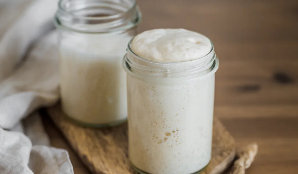 sourdough starter overlapping an a glass jar