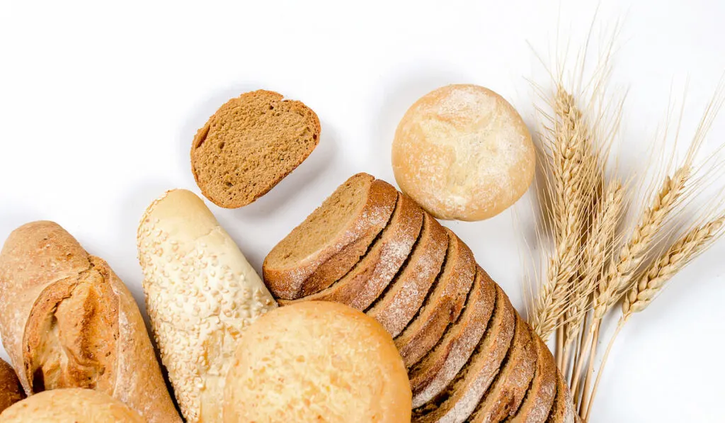 assortment of different types of bread on white background