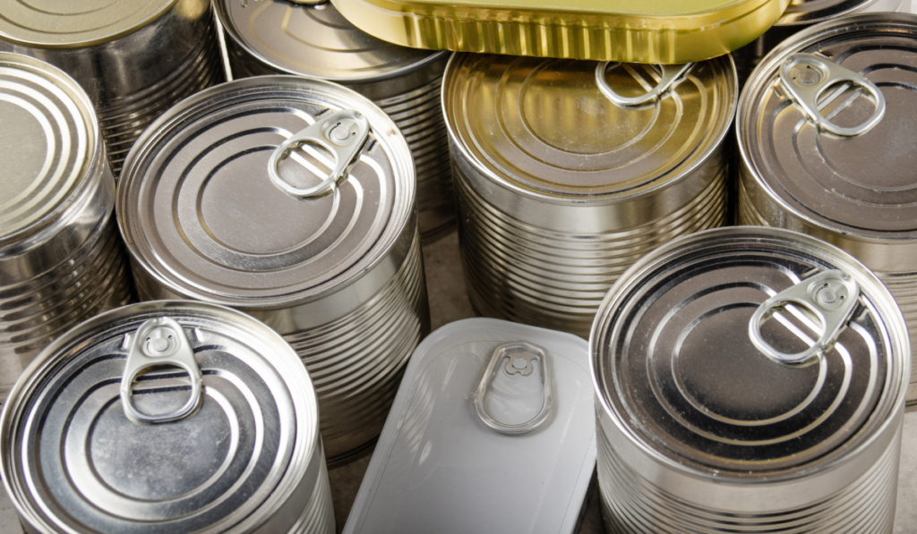 canned foods in tin cans on kitchen table
