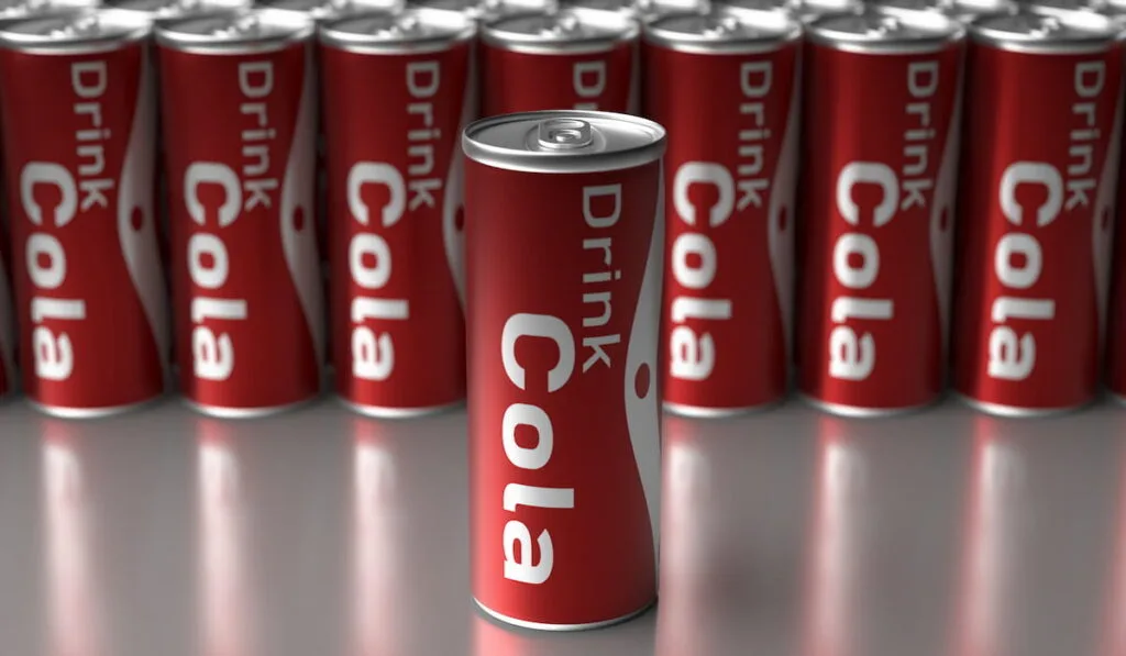 cola drink in a  can with other soft drink containers background