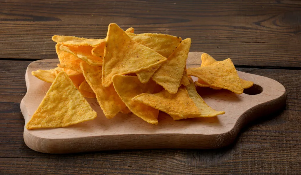 corn tortilla chips on a brown wooden background 