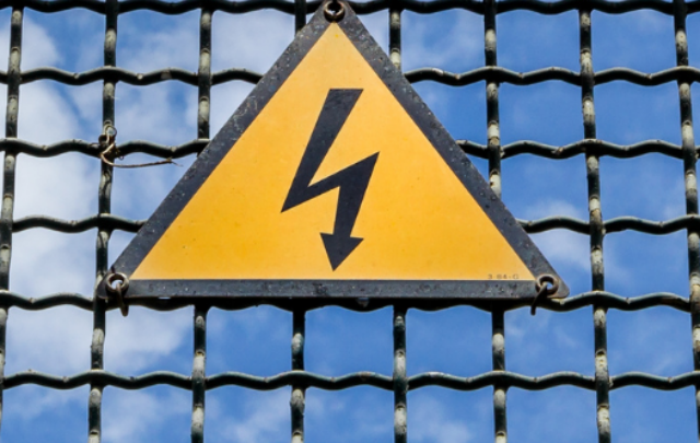 cropped-Electrical-hazard-sign-placed-on-a-metal-fence-ee220513.png