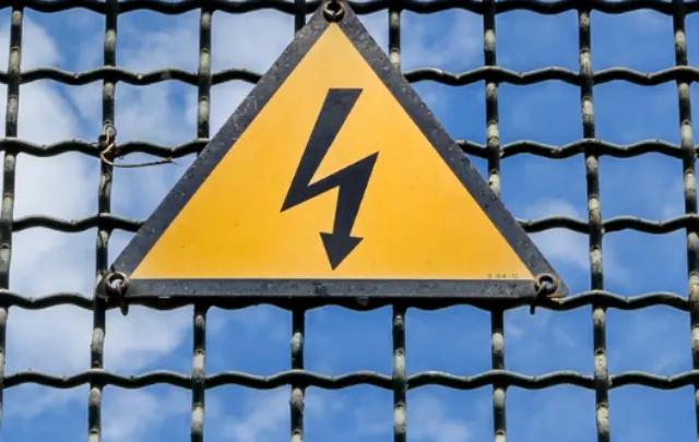 cropped-Electrical-hazard-sign-placed-on-a-metal-fence-ee220513.png