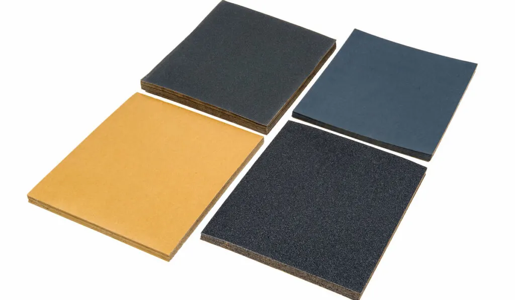 different kind of sandpapers on white background