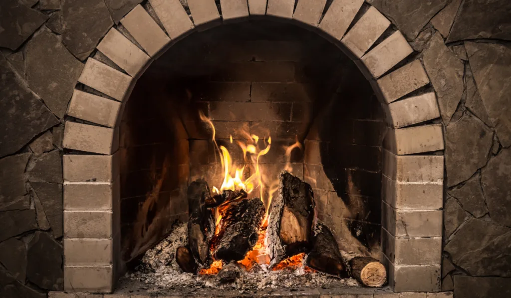 close up view of a fireplace with stone wall