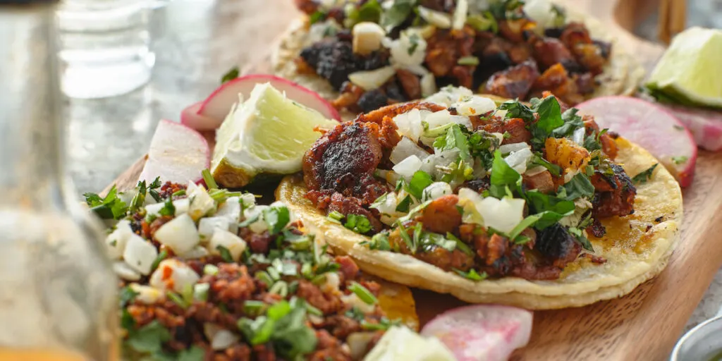 mexican street tacos with carne asada on corn tortillas platter