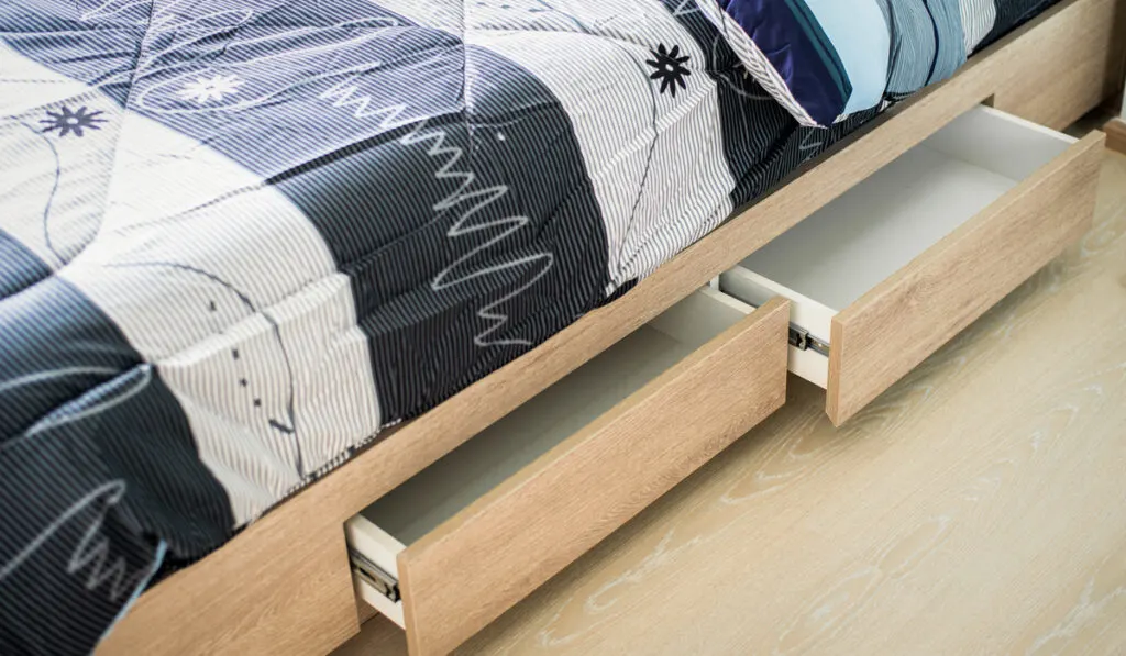 opened drawer under modern bed