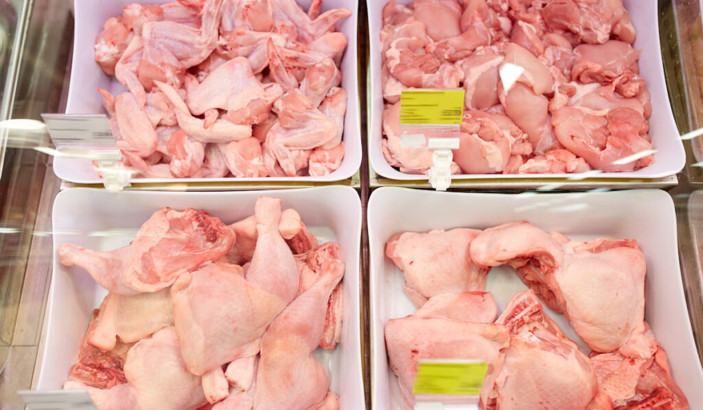 poultry meat in bowls at grocery stall 