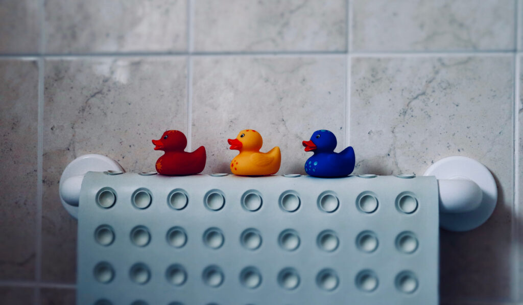 toy ducks sitting on rubber bath mat