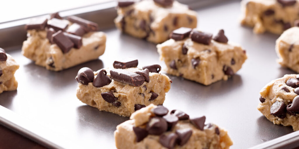 uncooked cookie dough on a baking sheet pan