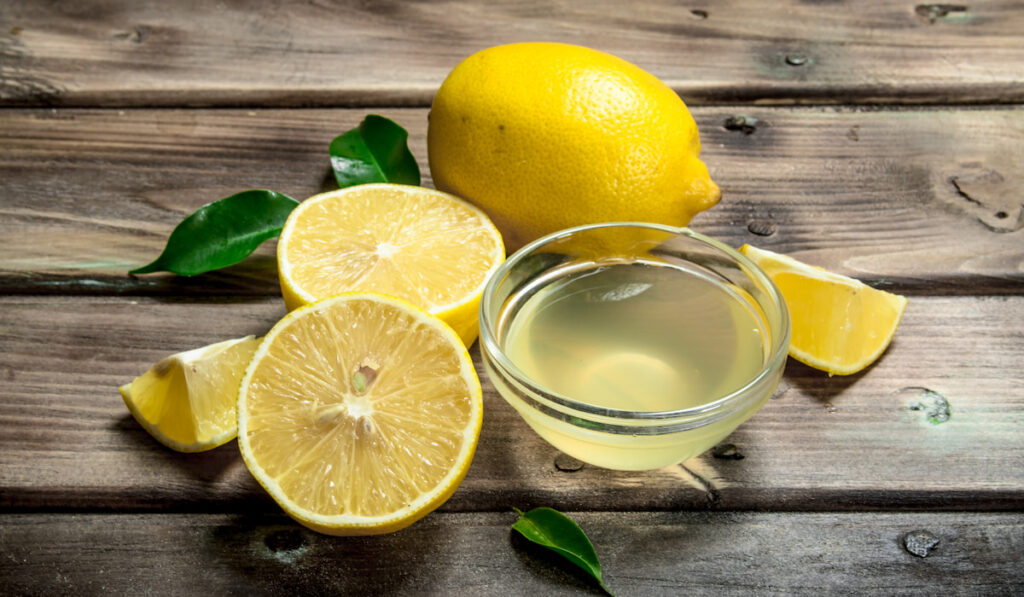 whole and sliced lemon and lemon juice in bowl