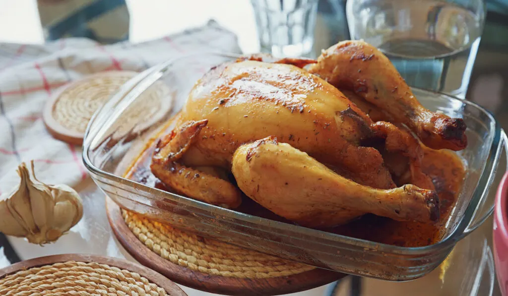 whole roasted chicken in glass form for baking 