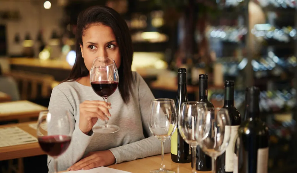 woman smelling different type of wines 