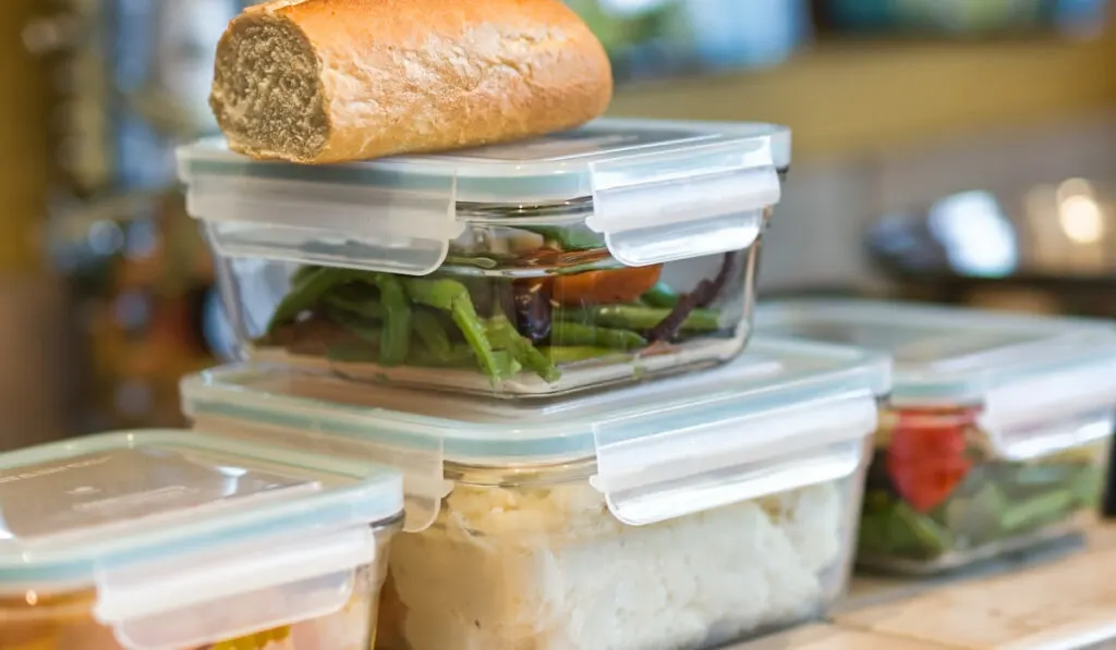 Close-up of containers of leftovers food on kitchen counter